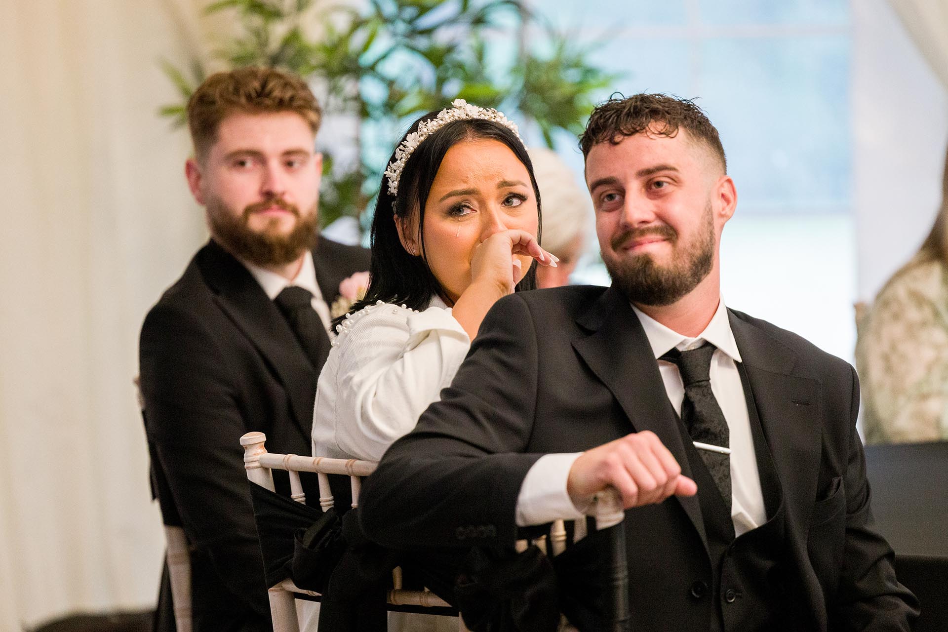 Photograph of bride with a tear in her eye during speeches