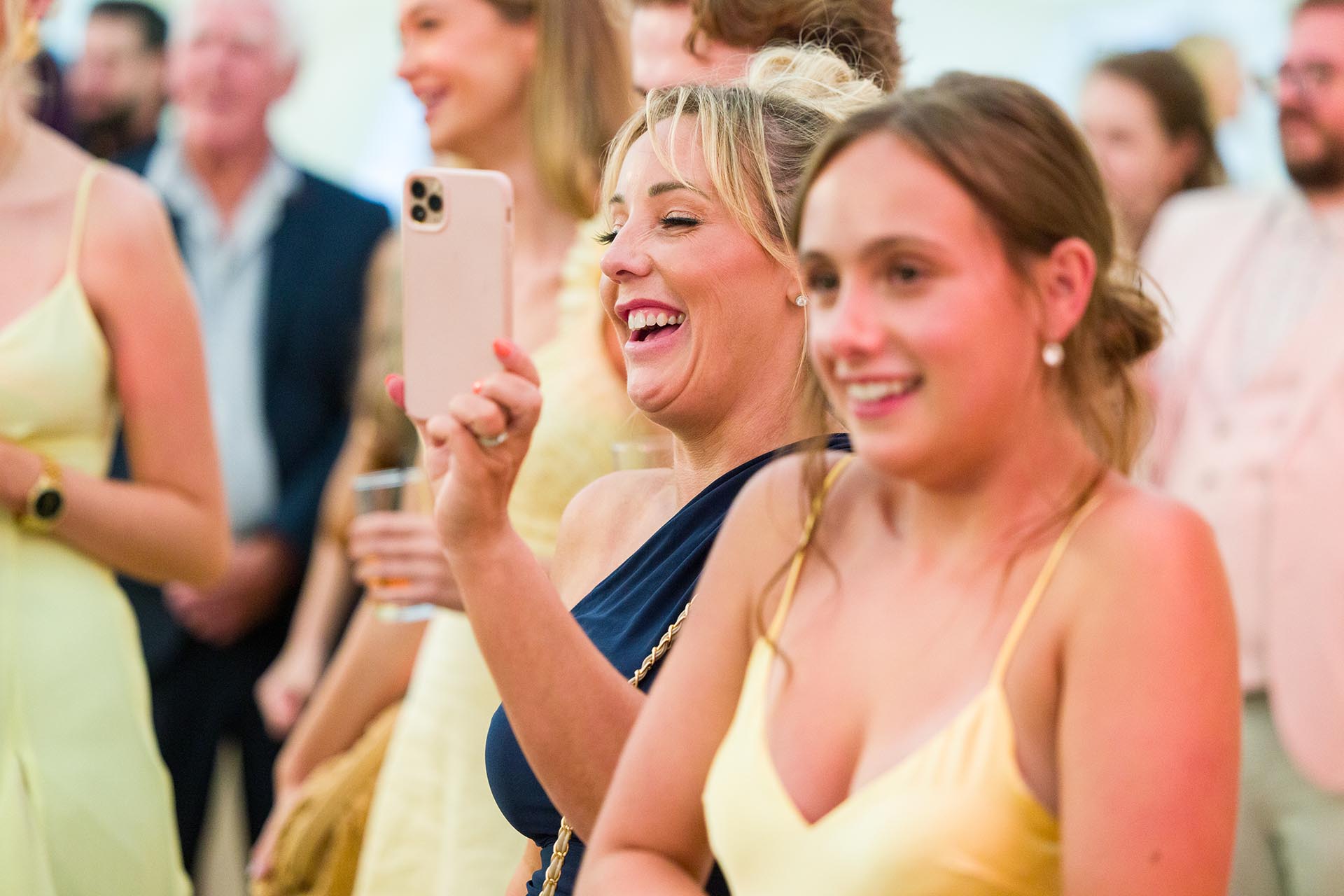 Photograph of wedding guests laughing during speeches