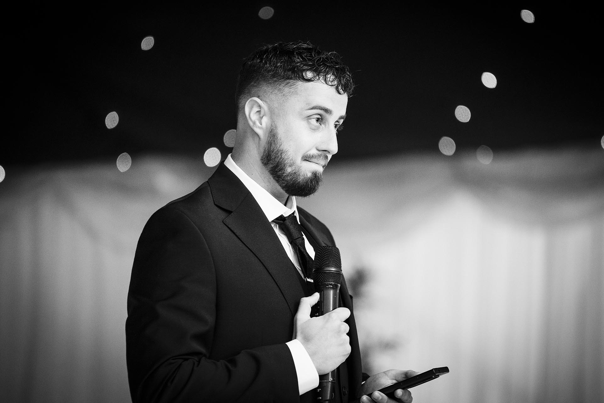 Black and white photograph of groom making speech