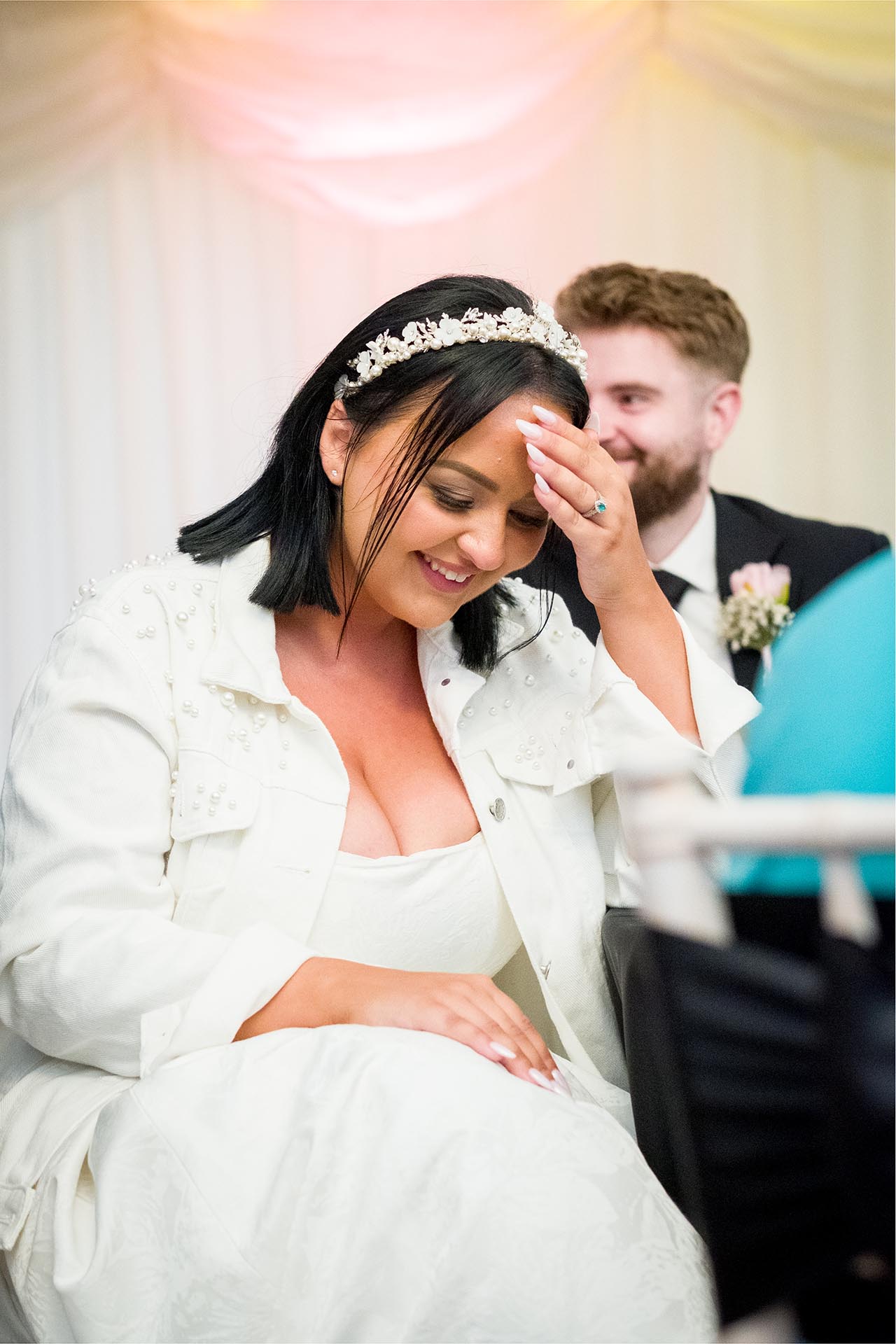 Photograph of bride laughing during speeches