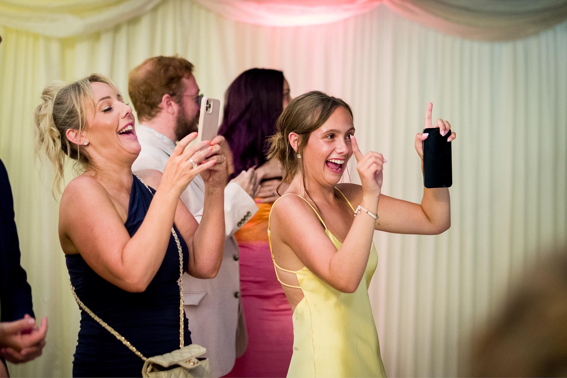 Photograph of wedding guests laughing and dancing