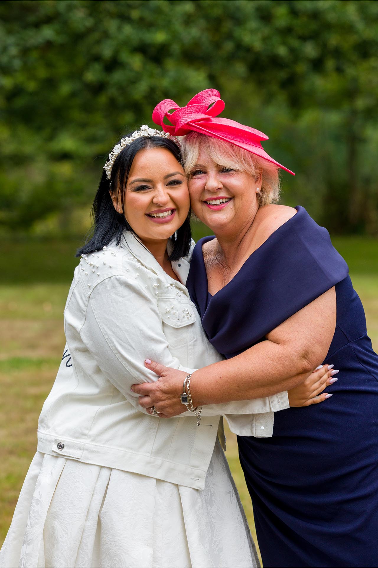 Photograph of bride hugging her mother