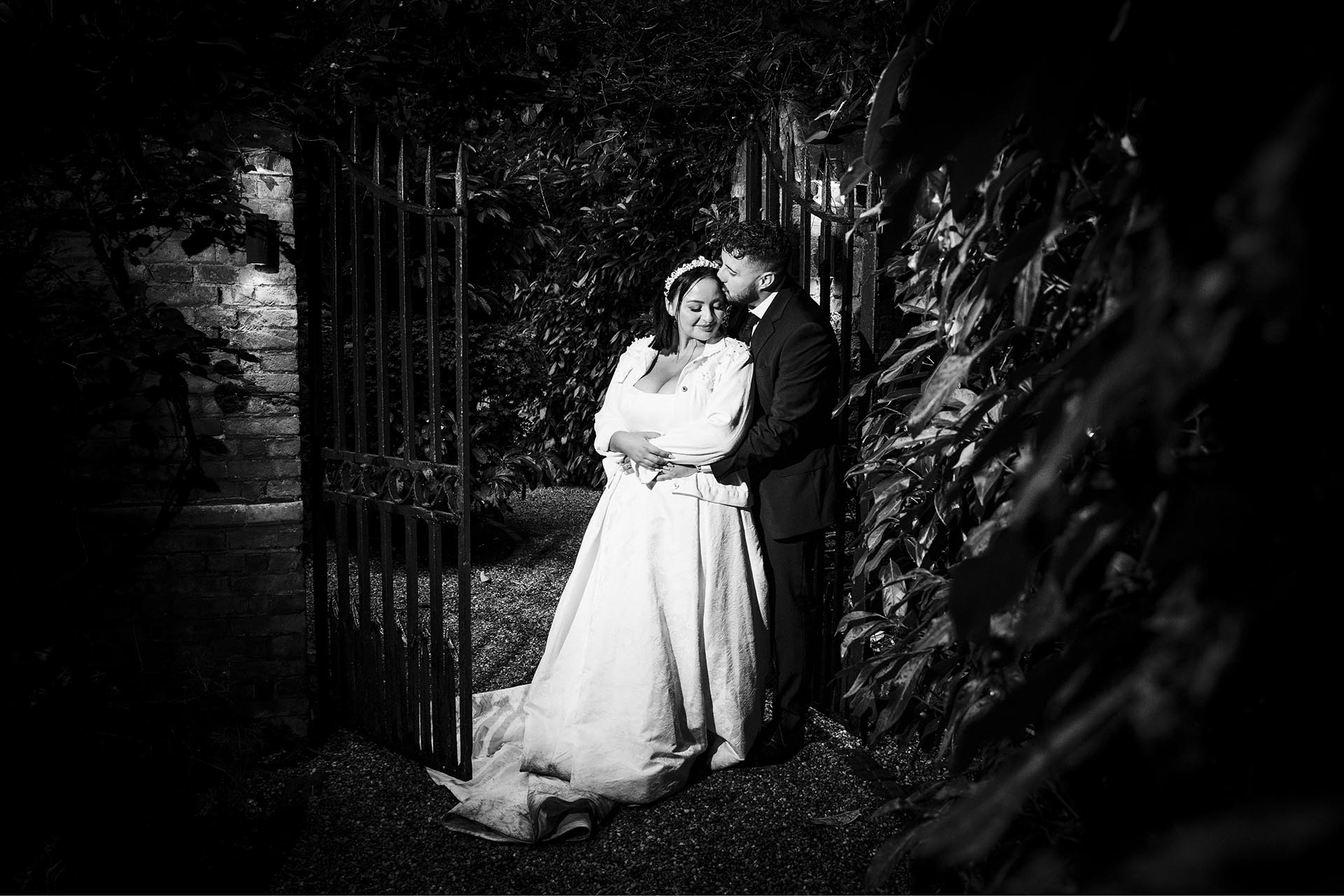Black and white photograph of bride and groom hugging at Creeksea Place, Burnham-on-Crouch, Essex