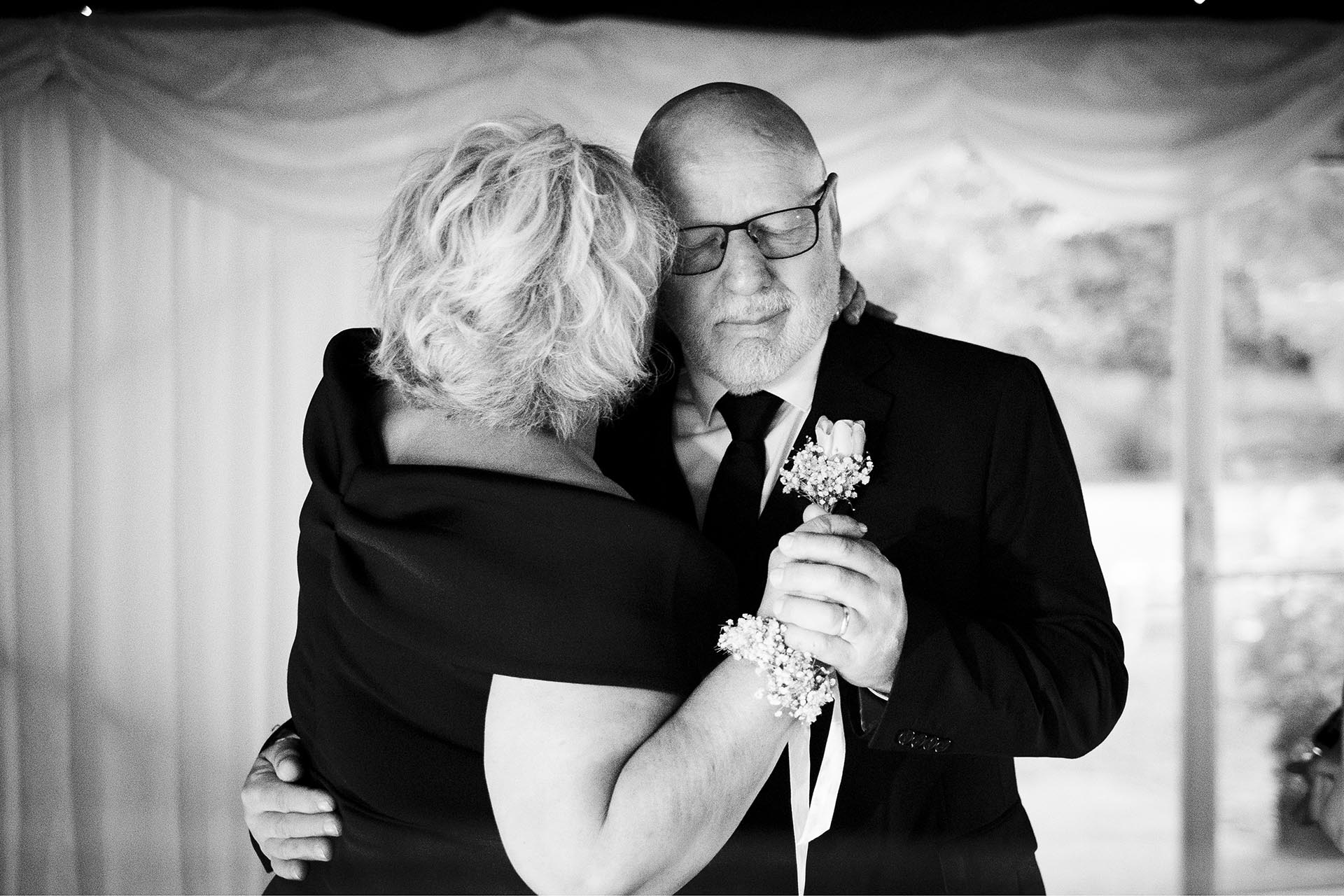 Black and white photograph of wedding guests dancing at Creeksea Place, Burnham-on-Crouch, Essex