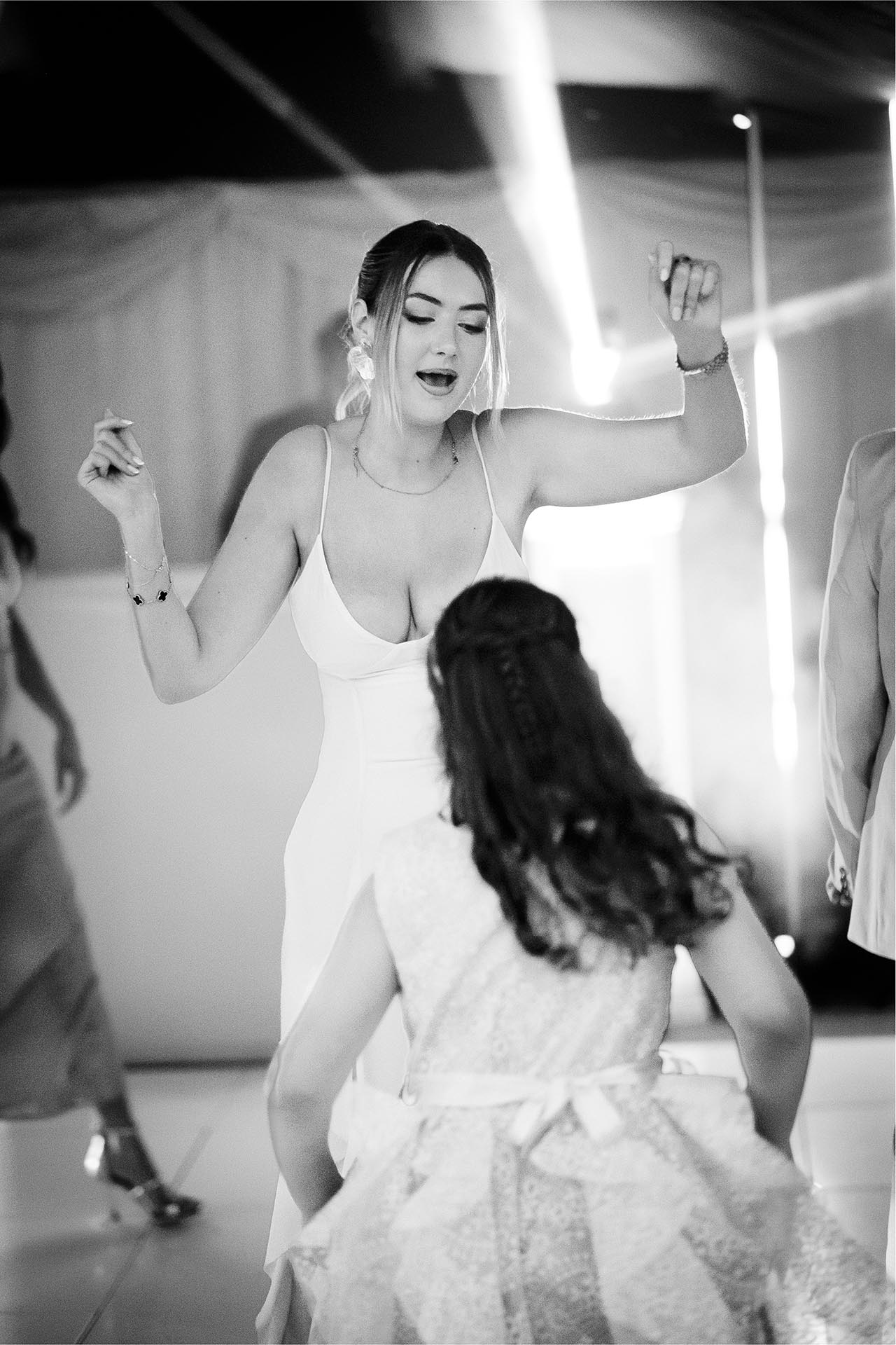 Black and white photograph of wedding guest dancing at Creeksea Place, Burnham-on-Crouch, Essex