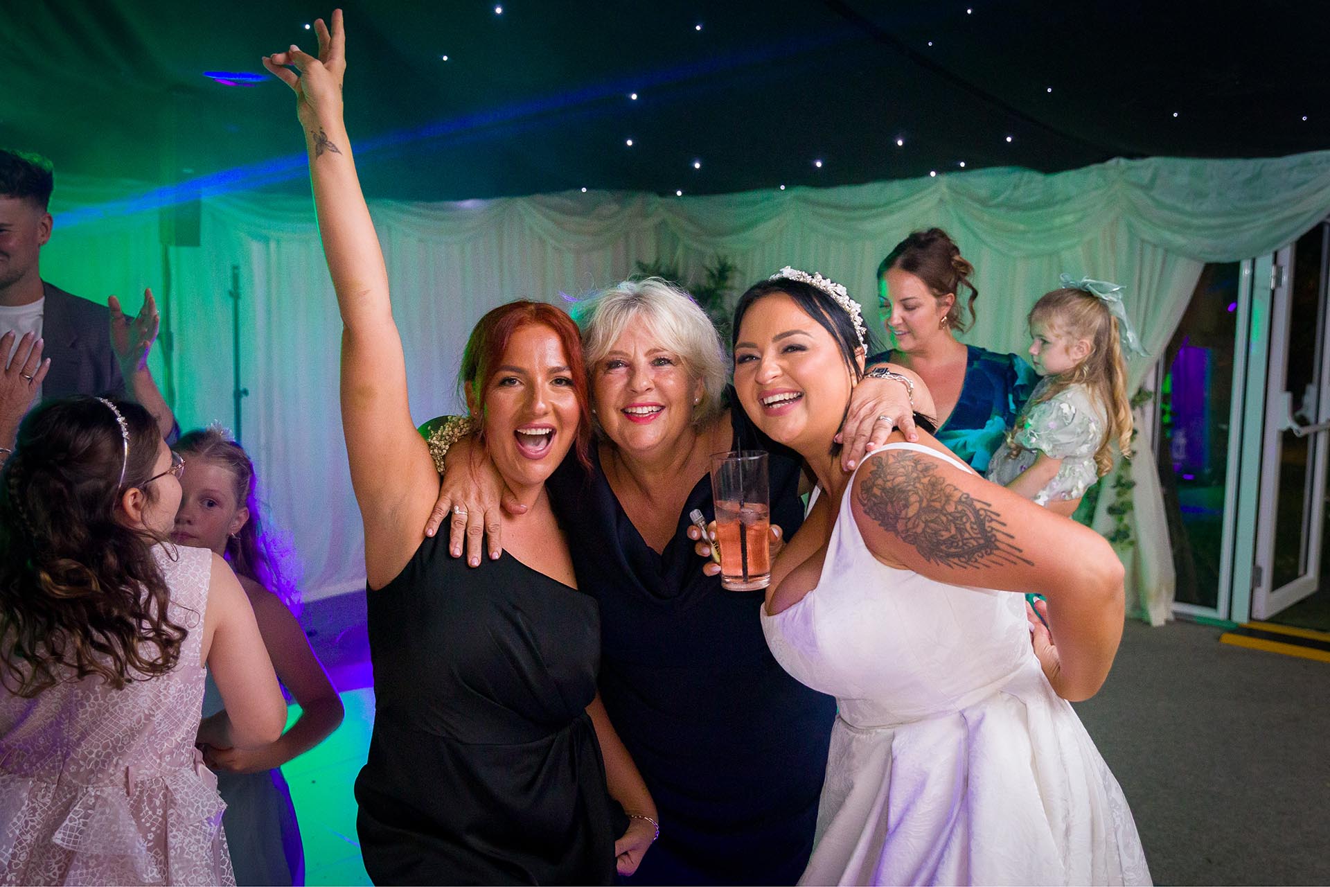 Photograph of bride celebrating with her mother and sister at Creeksea Place, Burnham-on-Crouch, Essex