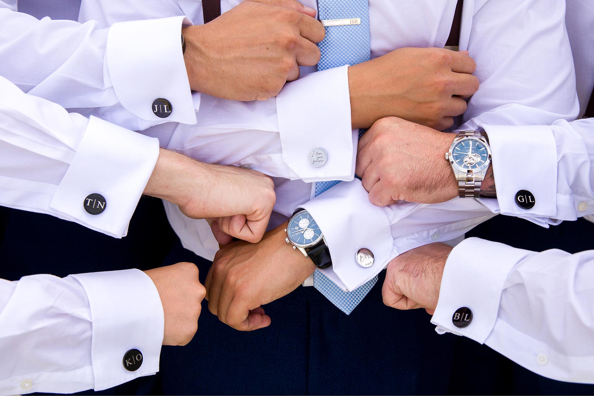 Close up photograph of all of the groomsmen'd cufflinks