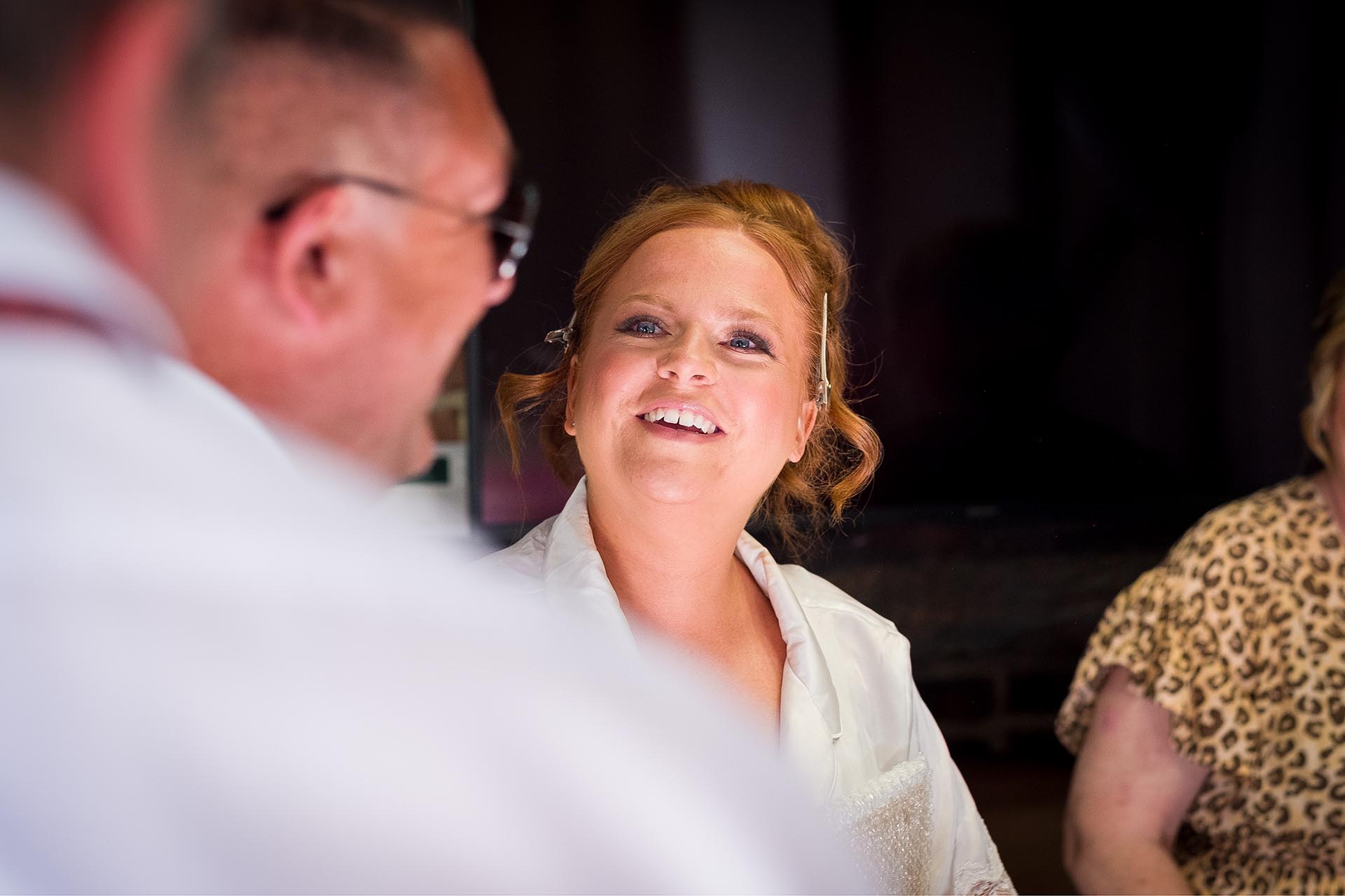 Bride laughing during make-up preparations