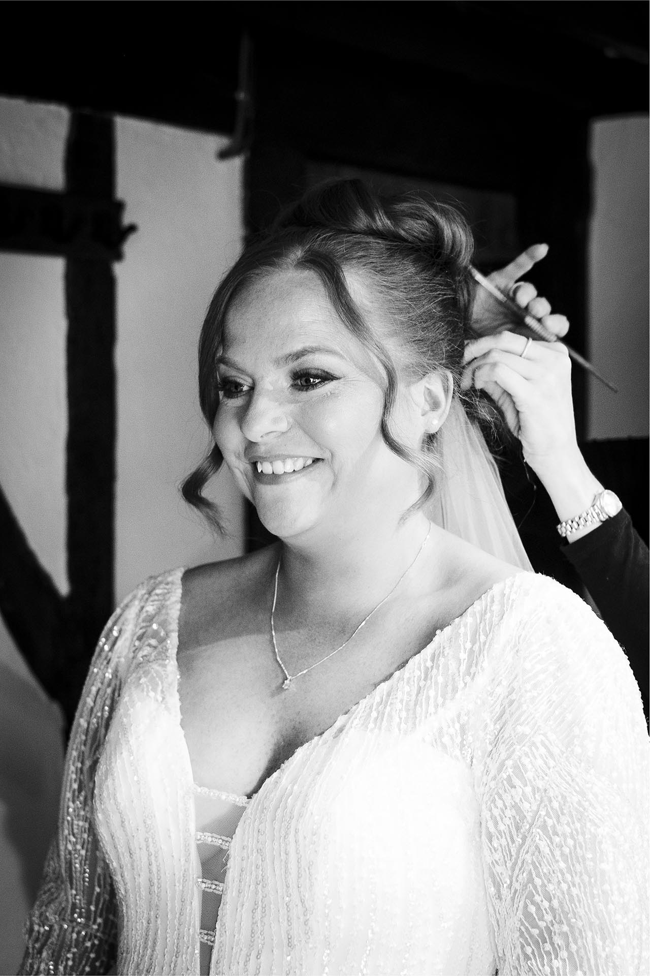 Black and white photograph of bride smiling