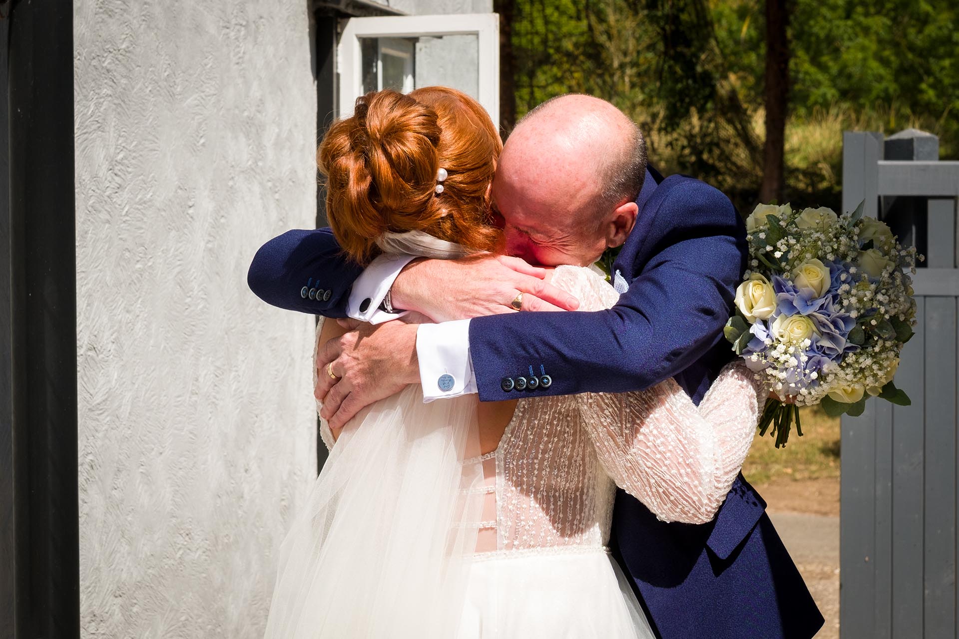 Father of the bride hugging his daughter