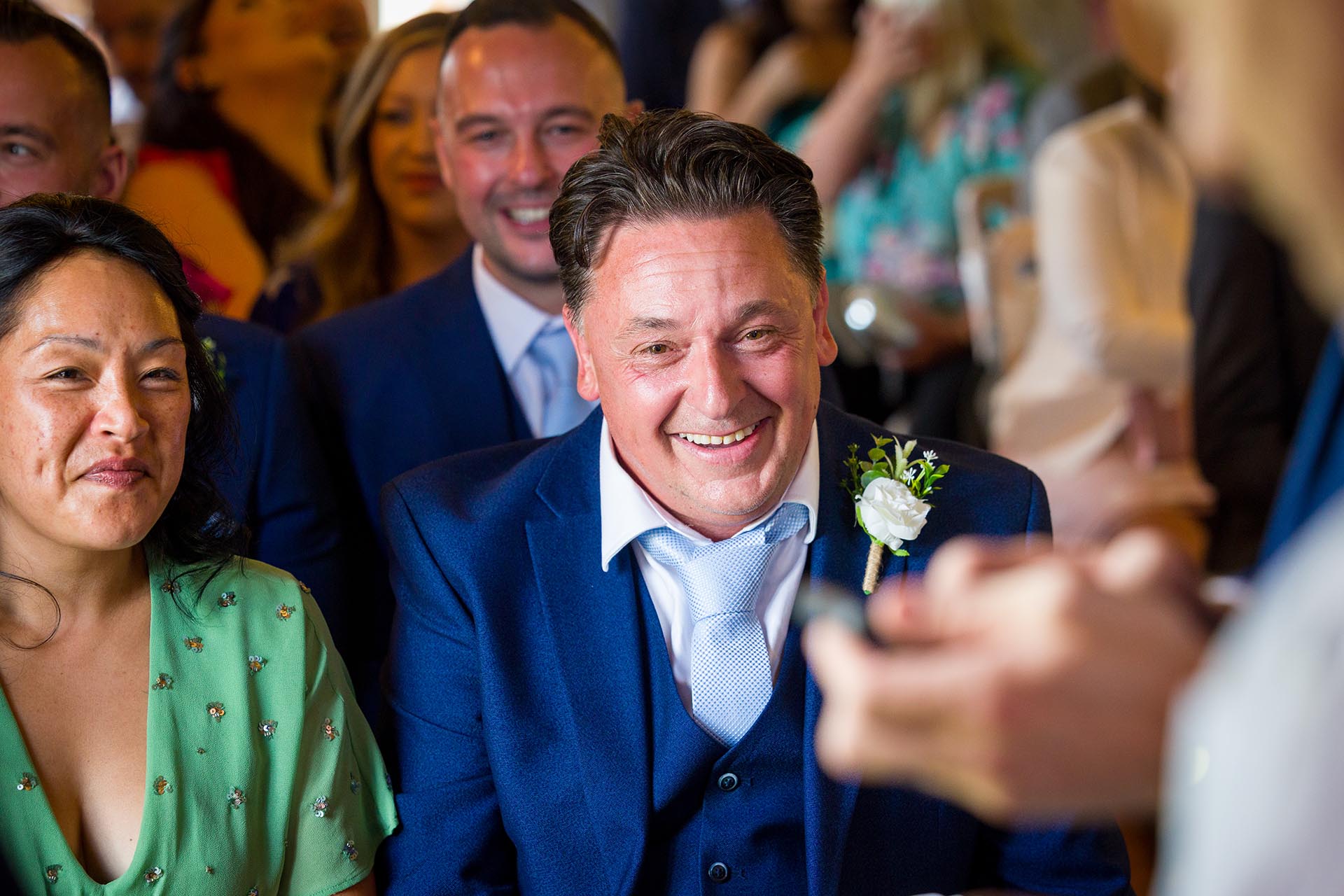 Wedding guests laughing in the ceremony room