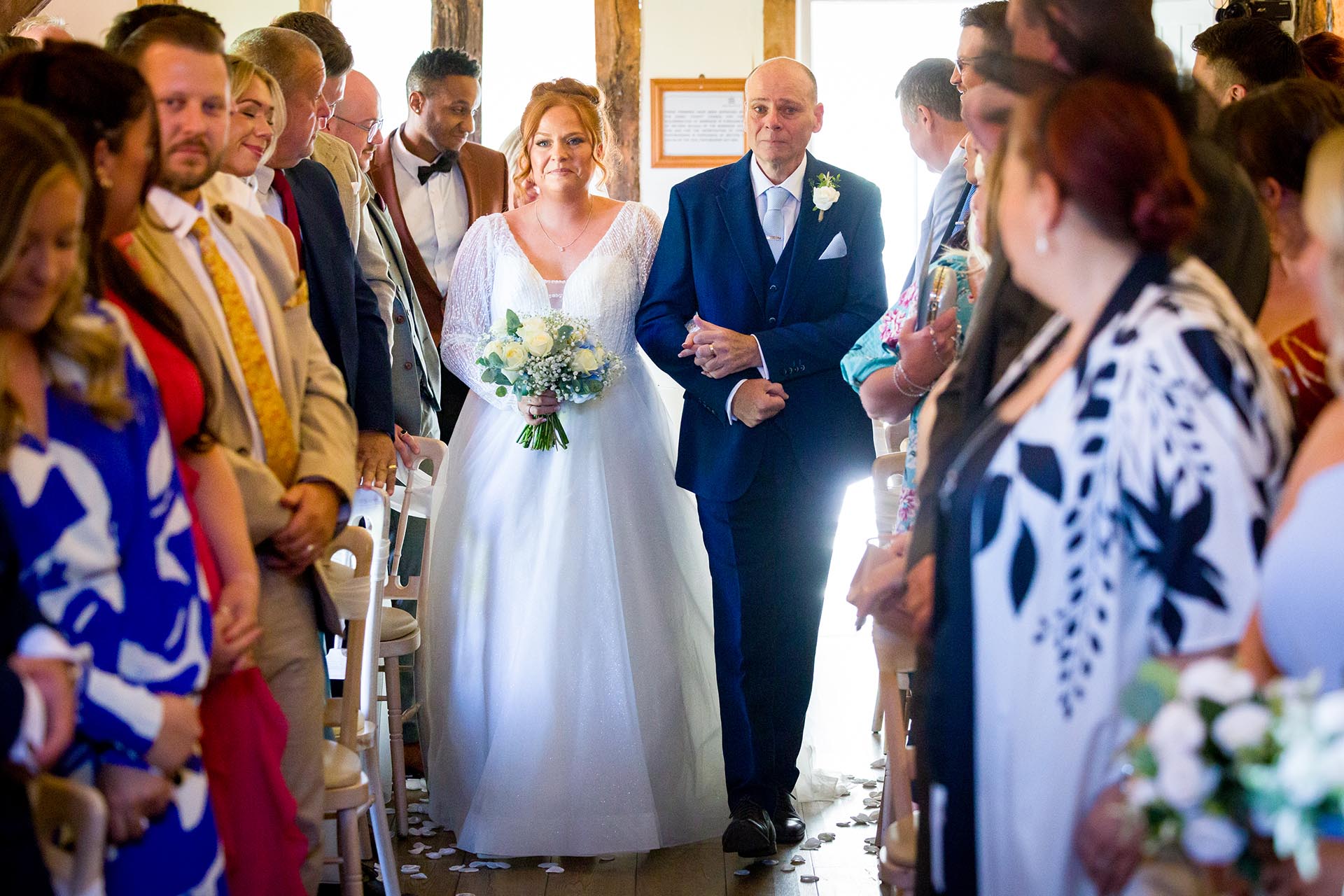 A bride walking down the aisle with her father