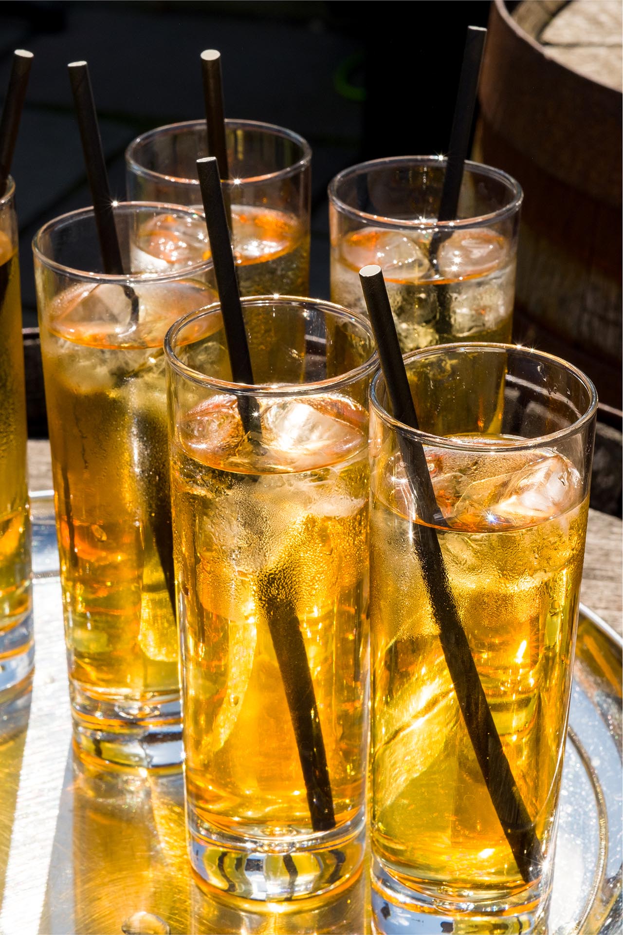 Close up photograph of full glasses with straws