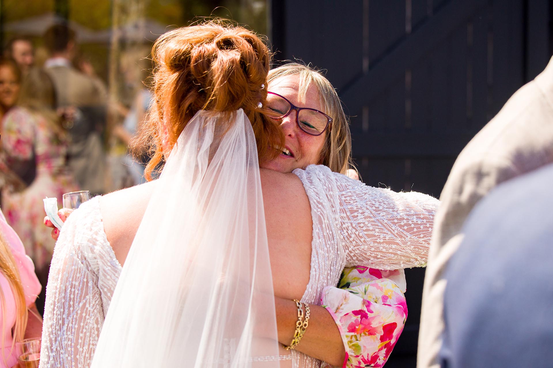 A wedding guest hugging the bride