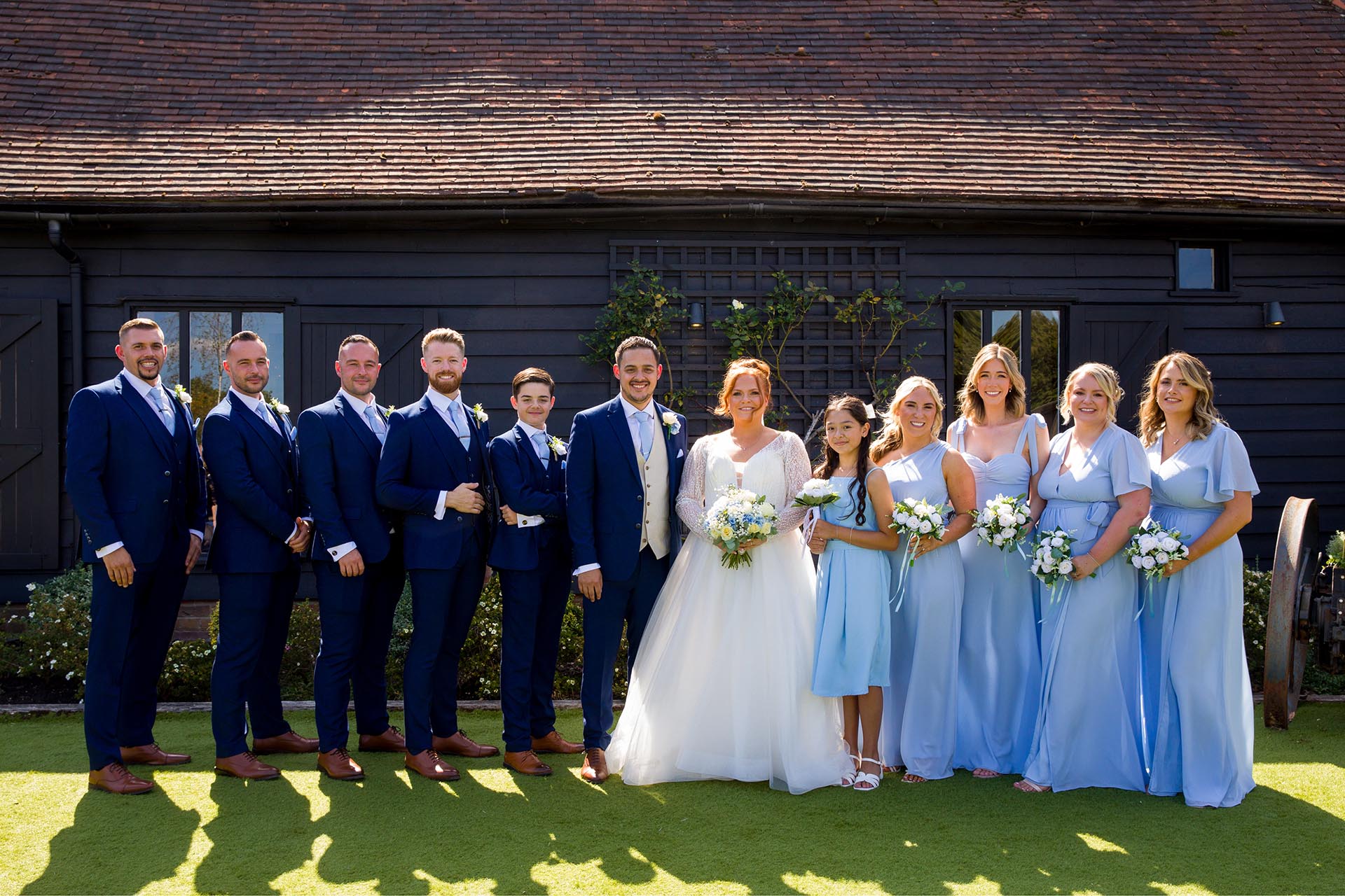 Group photograph of bride and groom with groomsmen and bridesmaids