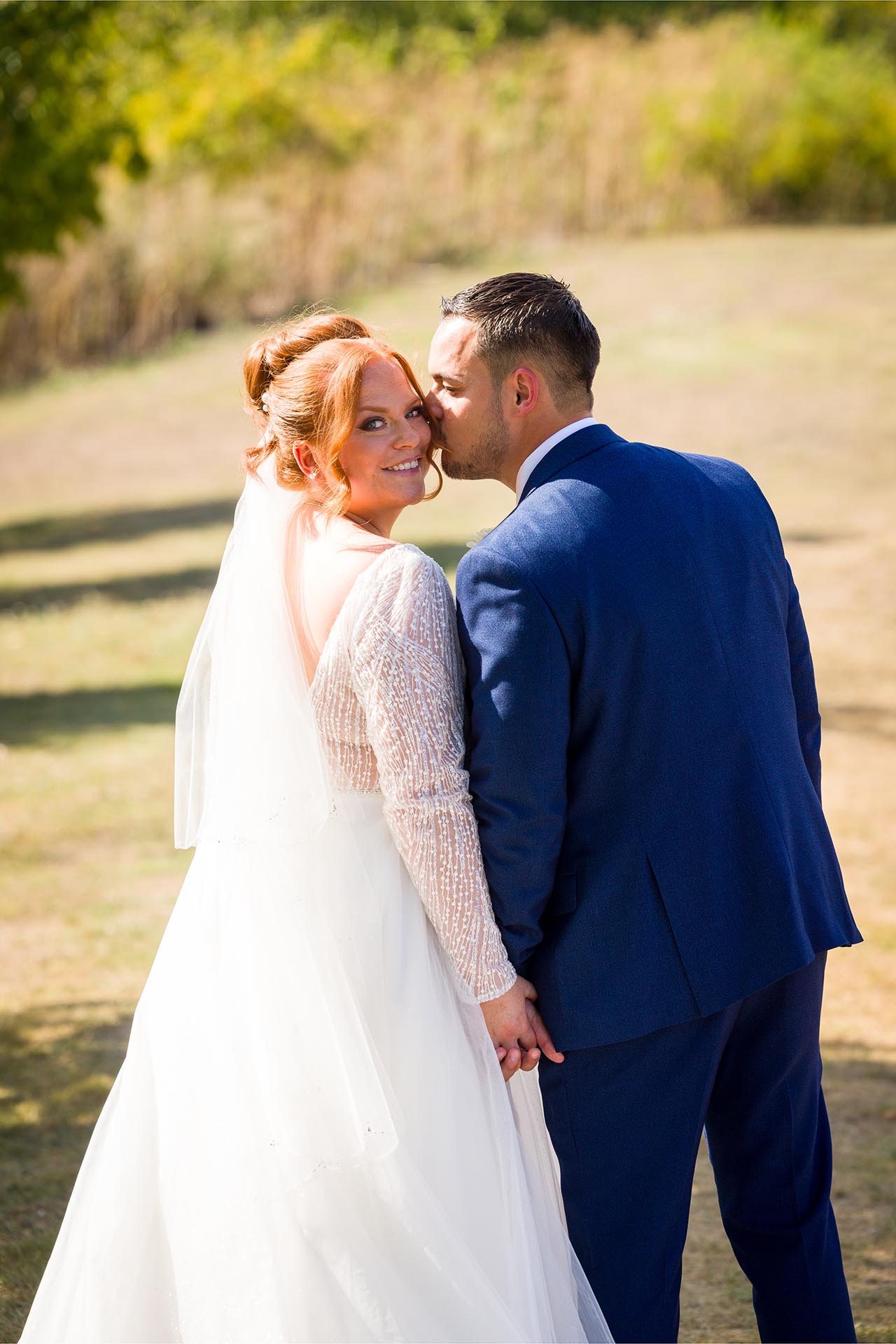 Groom kissing his bride