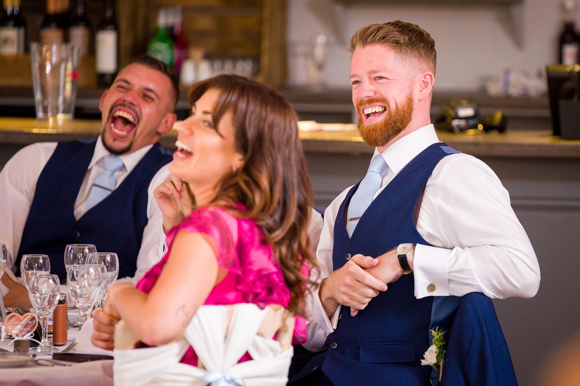 Photograph of wedding guests laughing