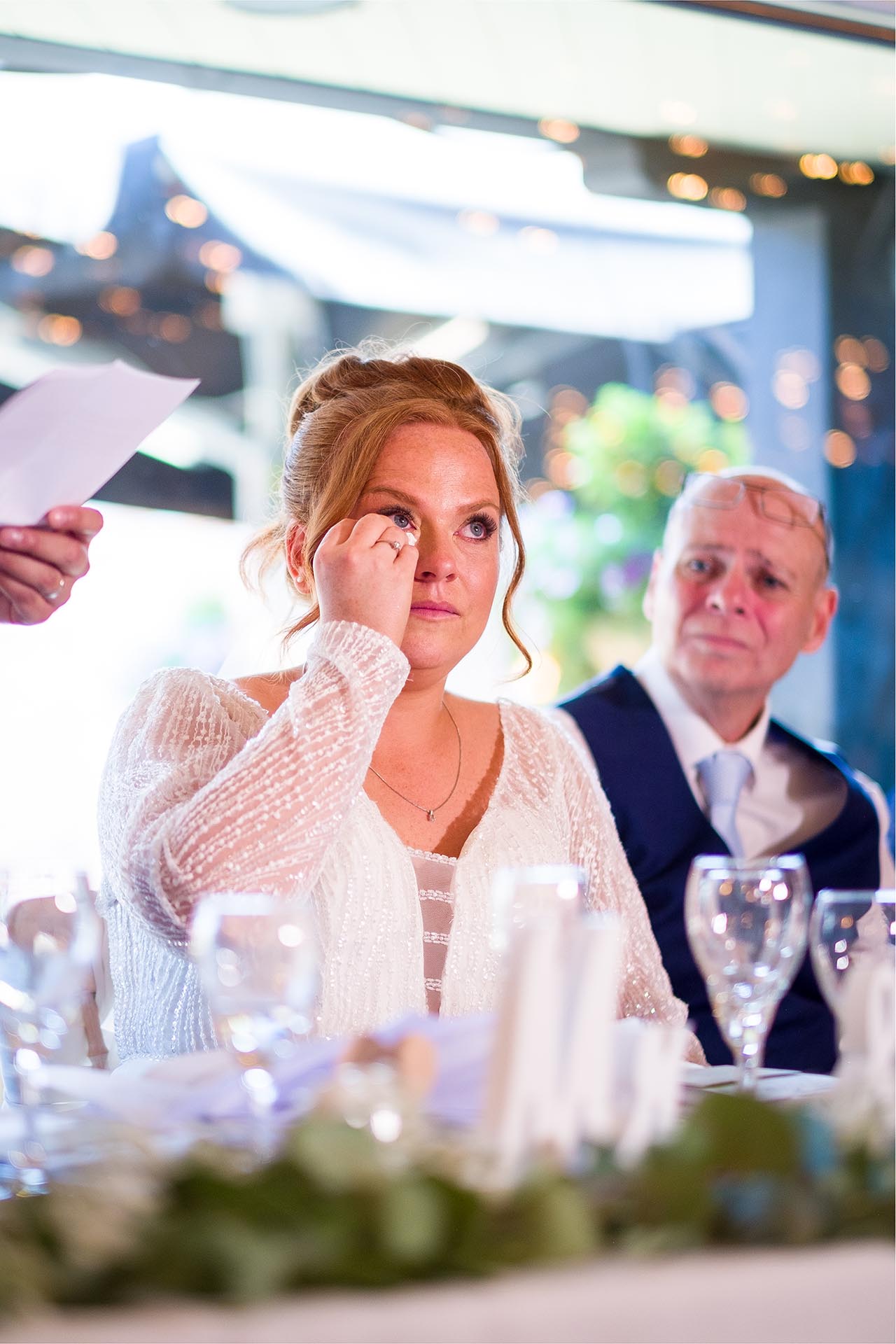 Emotional bride wiping a tear