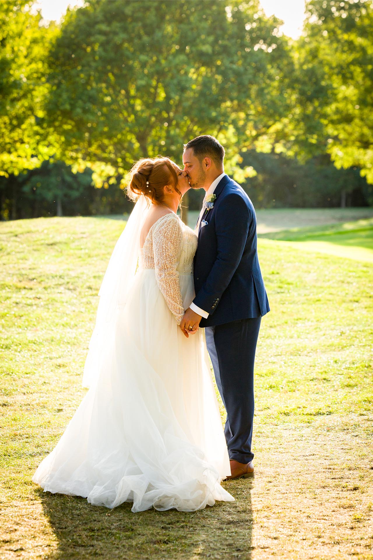Bride and groom kissing in the grounds at Little Channels, Essex