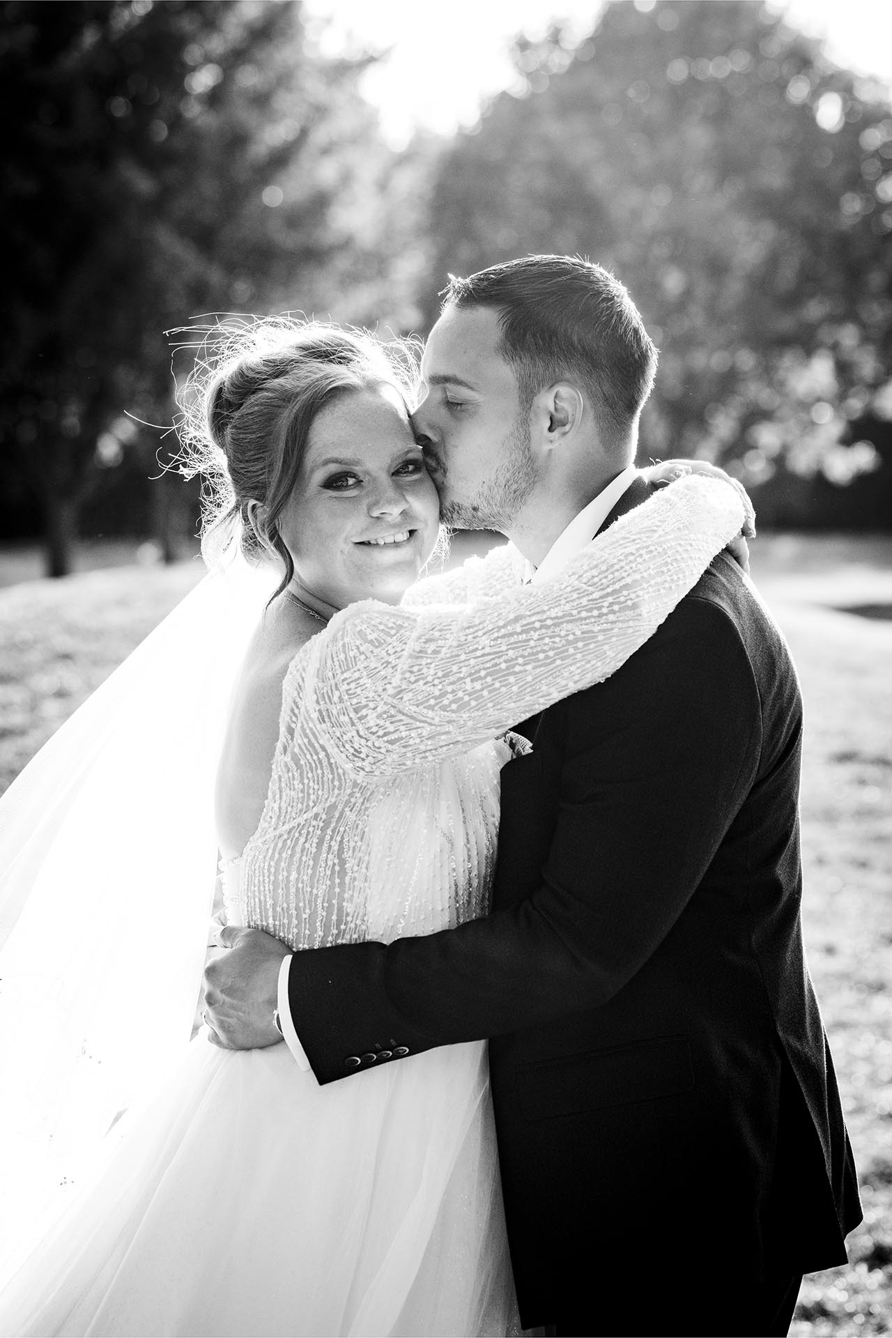 Black and white photograph of bride and groom in the late afternoon sun at Little Channels, Essex