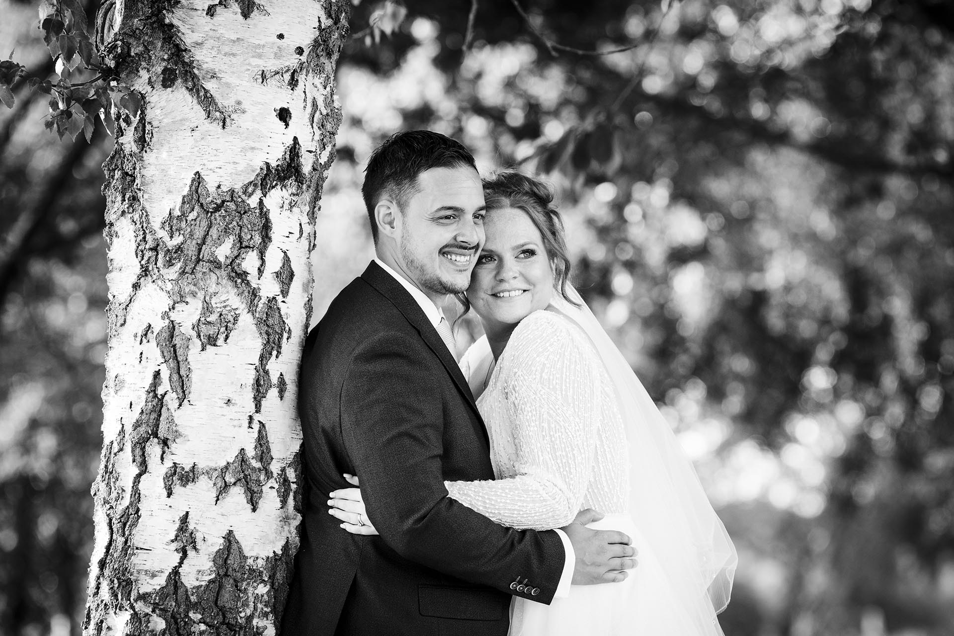 Black and white photograph of the bride and groom looking into the distance at Little Channels, Essex