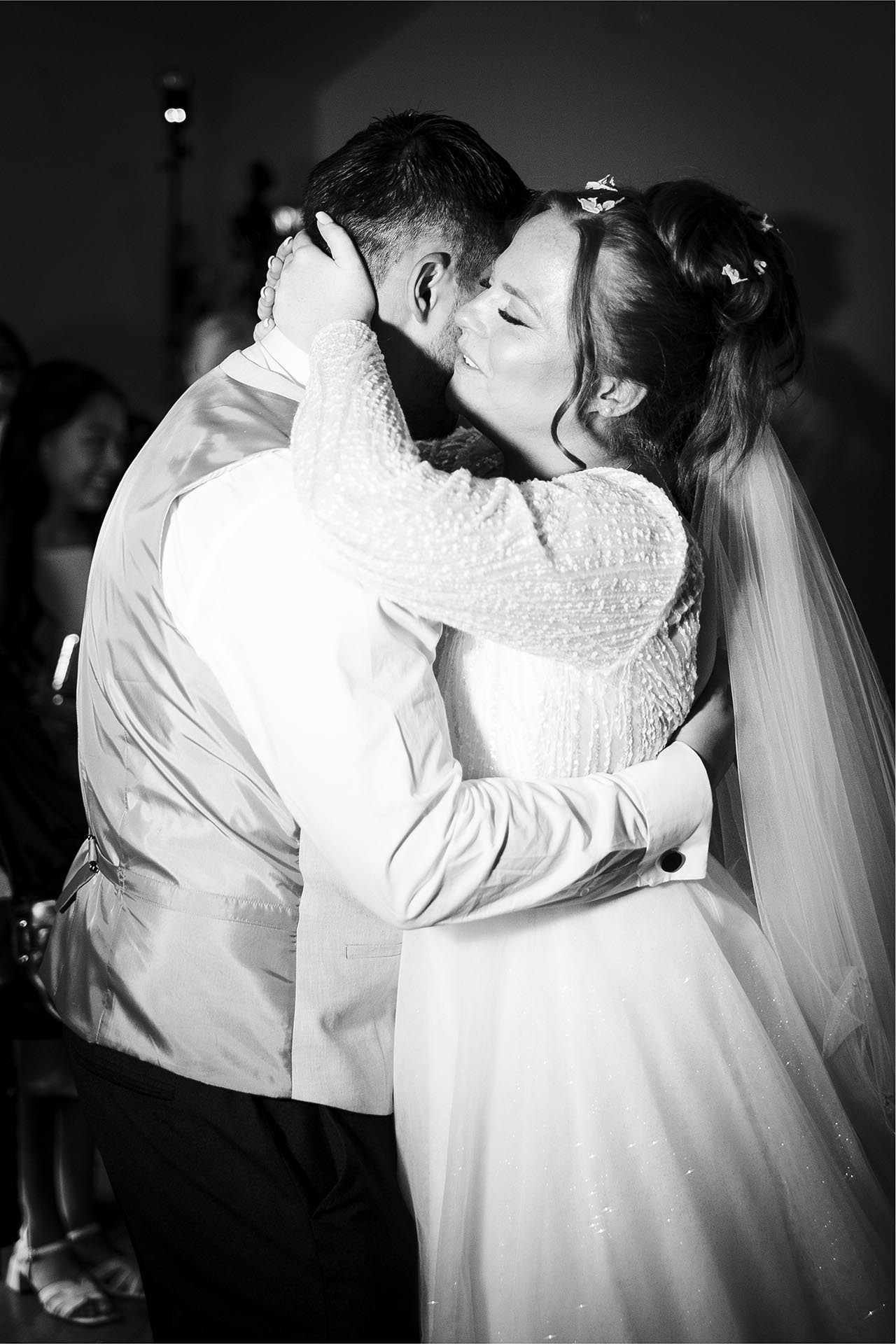 Black and white photograph of bride and groom during their first dance