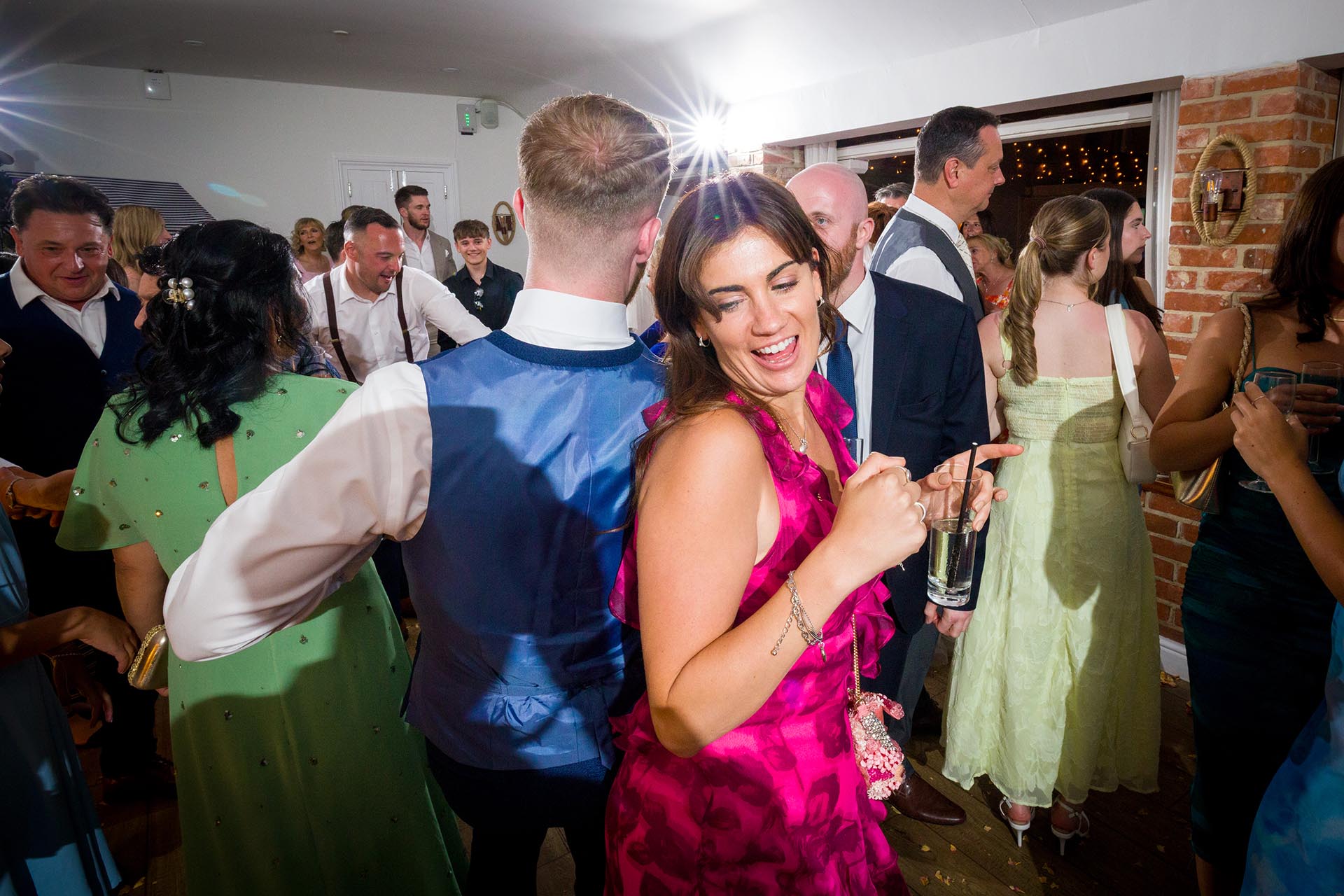 Colourful photograph of wedding guests dancing